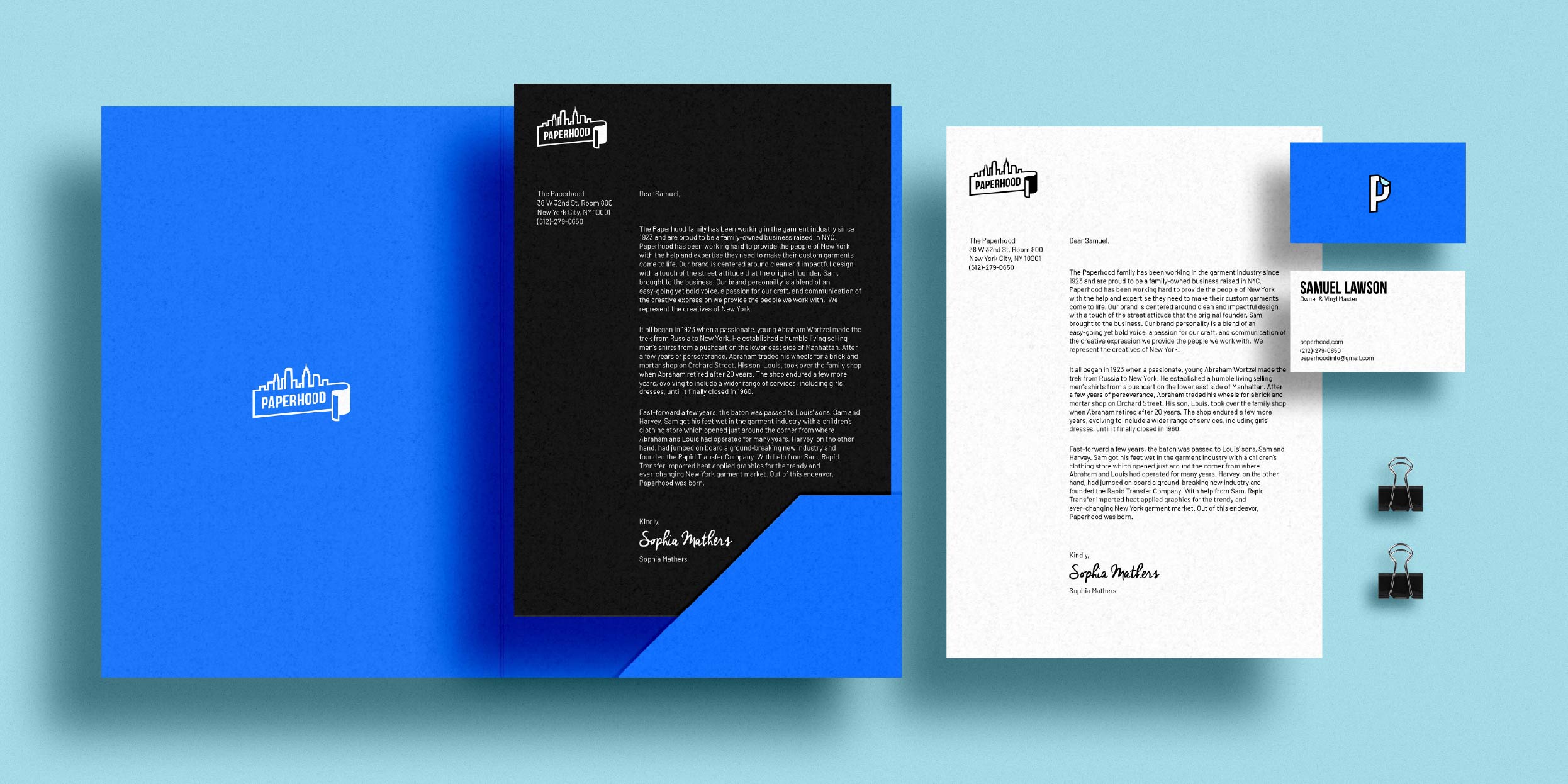 A bright blue folder laying open with a black letter-sized sheet of paper with white text on it placed neatly in the right side of the folder, a white letter-sized sheet of paper with black text on it laying to the right of the folder with a two business cards slightly overlapping the white letter-sized paper, one showing the front of the card and the other showing the back with two black binder clips sitting below them
