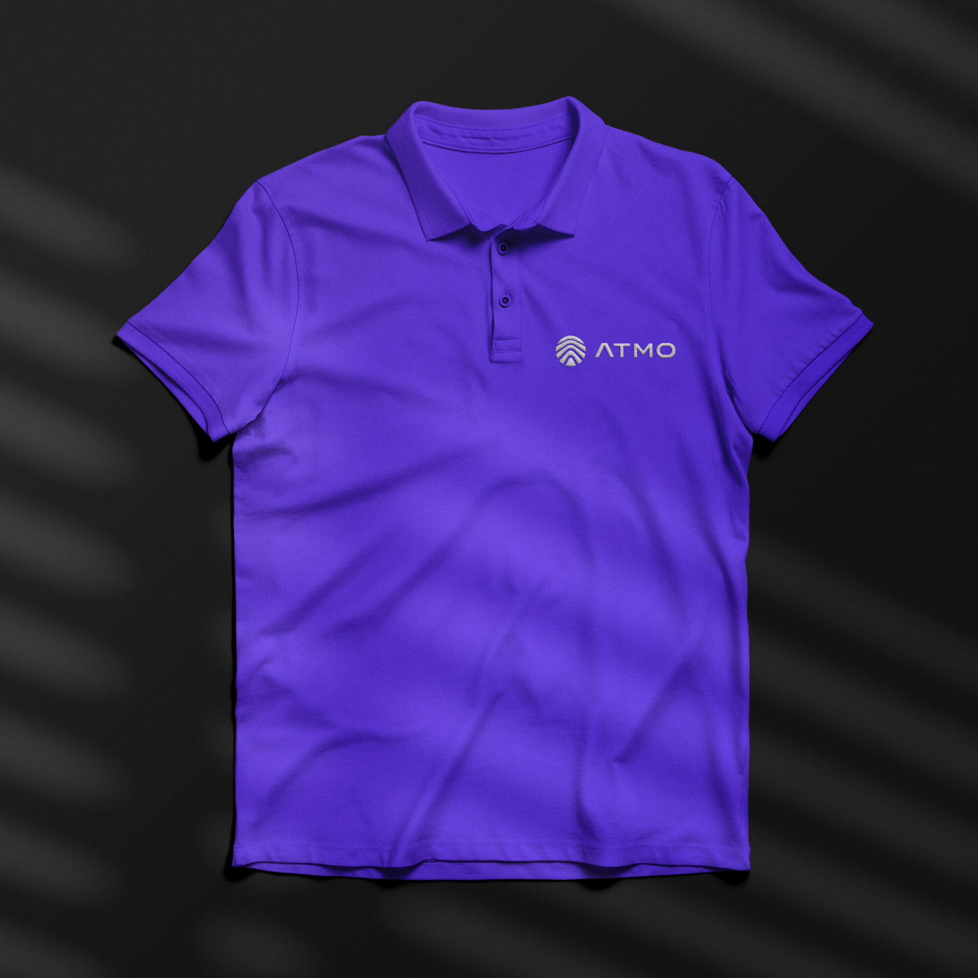 Purple polo shirt with Atmo logo embroidered on the left breast section