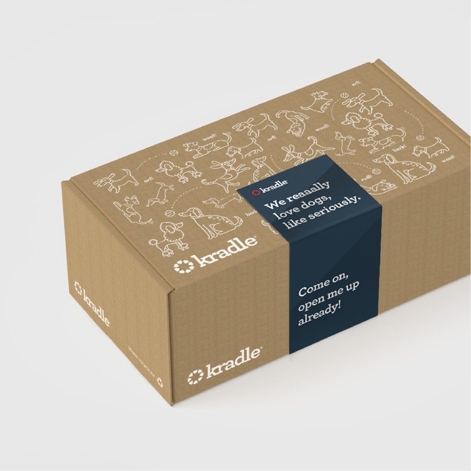 Cardboard box with white dog illustrations on top sealed with blue Kradle branded tape.