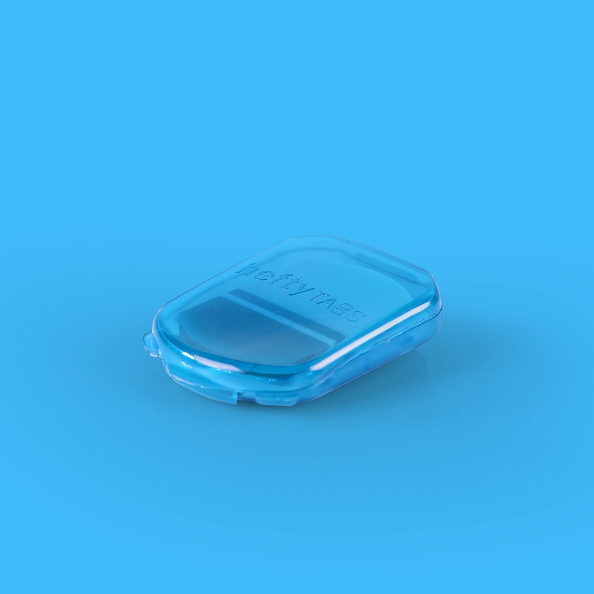 A small blue translucent container holding sticky tabs for office use, clipped shut.