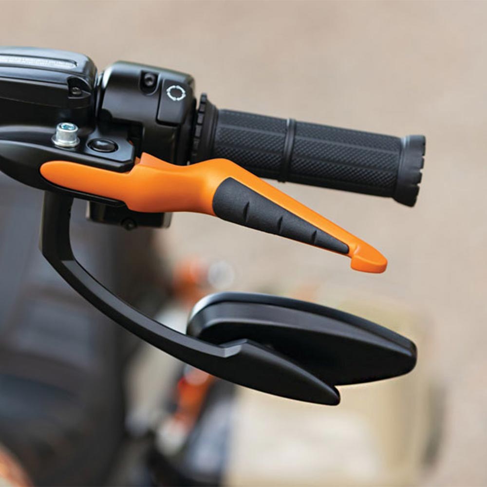 A close-up view of a motorcycle handlebar, the handle has orange accents.